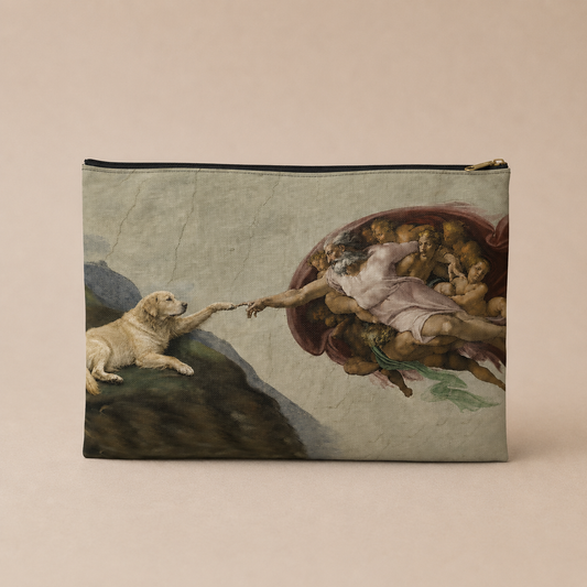 A rectangular zip pouch featuring a printed reproduction of Michelangelo's painting of God and Adam, with a golden retriever reaching toward Adam. The pouch is shown against a solid, warm beige background.
