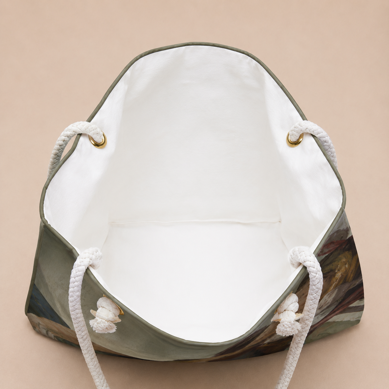 An open tote bag with a white interior, white rope handles, and a muted multicolor exterior featuring olive green, brown, and beige tones, shown on a solid beige background.