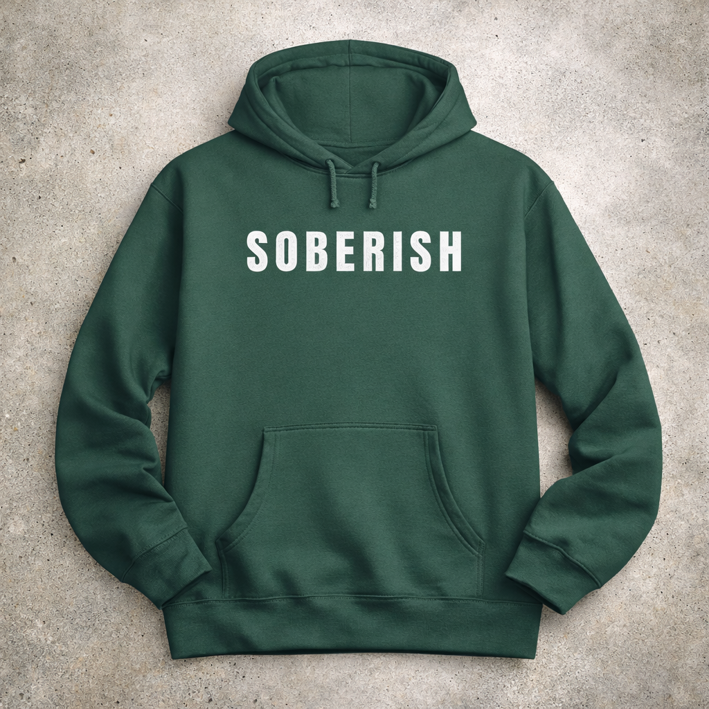 Green hoodie with 'SOBERISH' text on a concrete surface