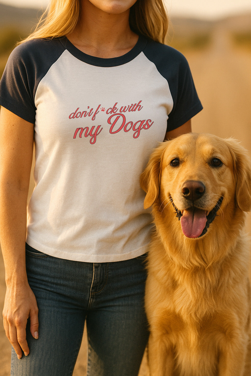 Person wearing a t-shirt with 'don't f*ck with my dogs' text standing next to a golden dog.