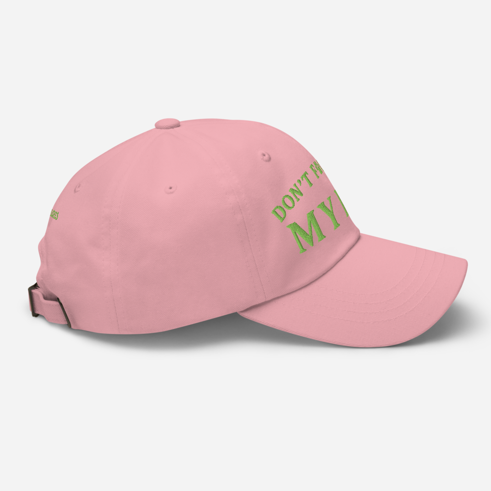 Pink cap with green text on a light gray background