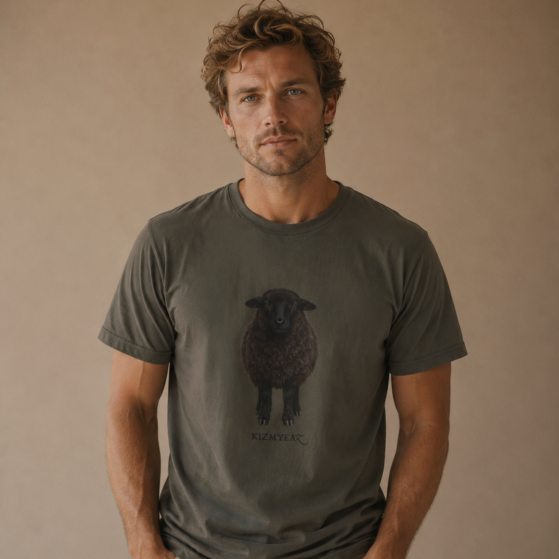A man wearing a dark gray t-shirt with a black sheep graphic and the brand name 'ROOSTER' printed below it, paired with light beige pants, set against a plain beige background.