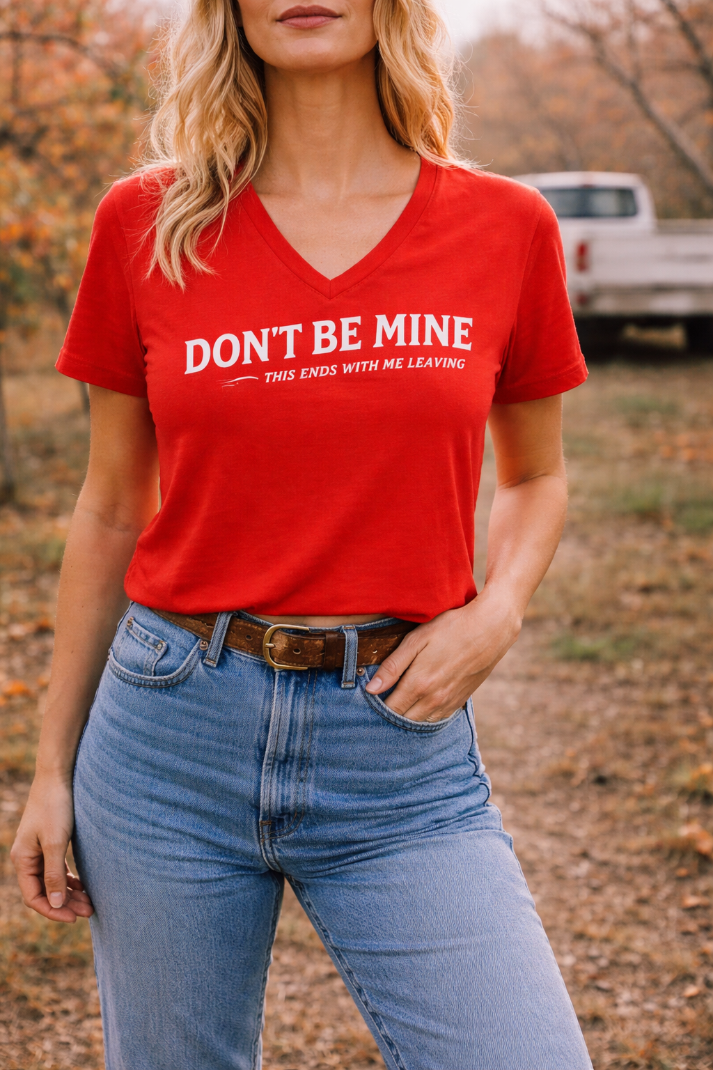 Person wearing a red t-shirt with text, standing outdoors.